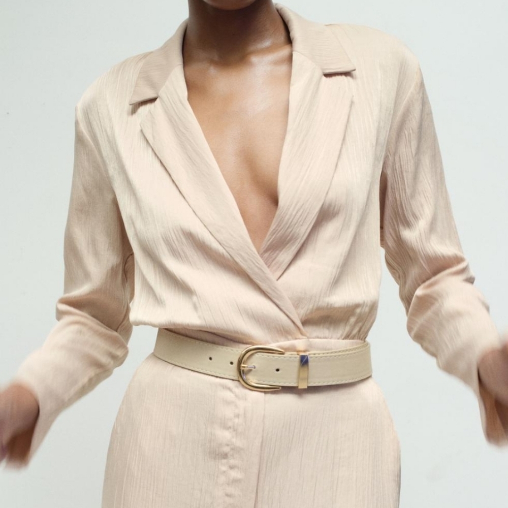 Zara beige wrinkled effect satin jumpsuit with a lapel collar and long sleeves.